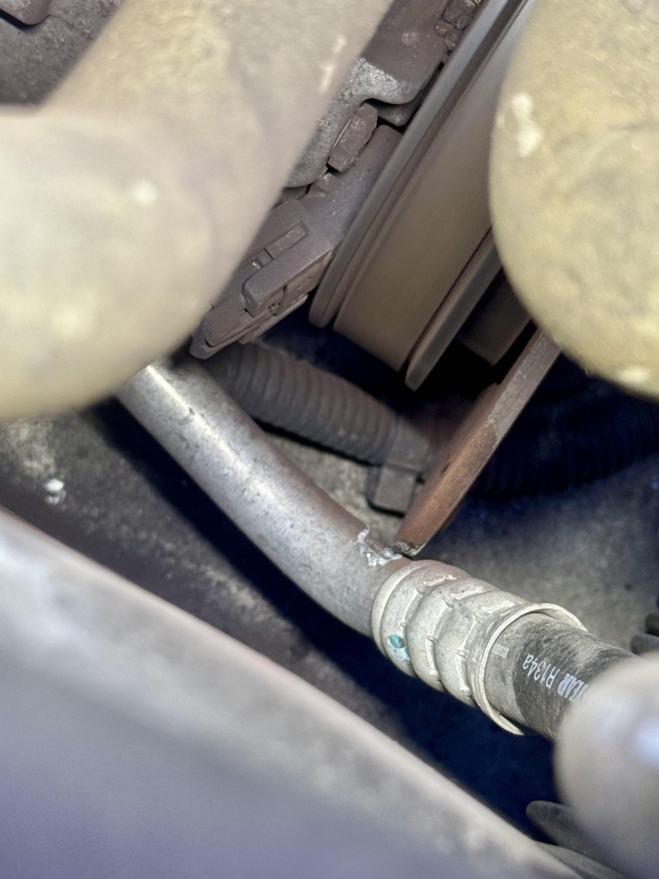 Corvette A/C line beside the loose clutch face, showing the contact area being monitored.