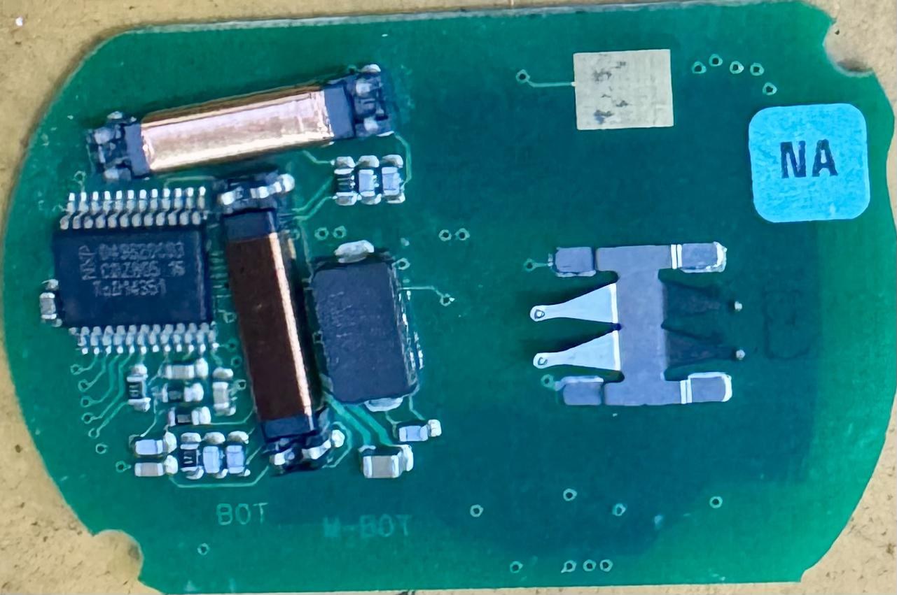 Reverse side of the Corvette key-fob circuit board with battery contacts and electronic components.
